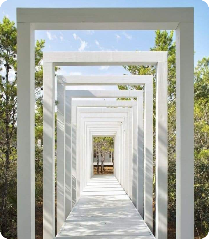 Landscaped garden walkway with symmetrical arched greenery